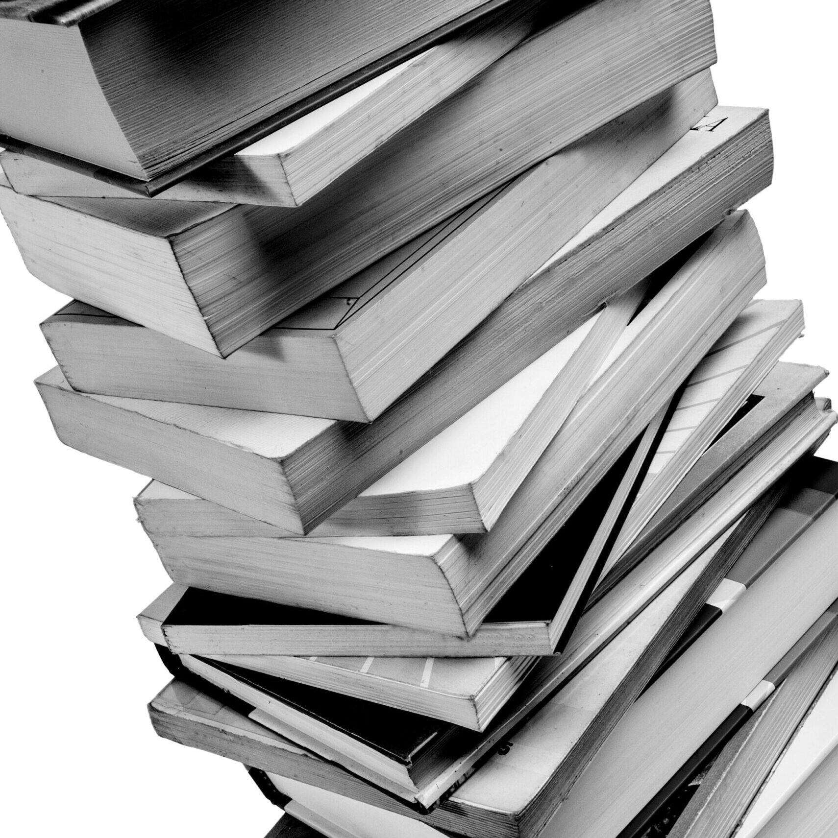 Pile of used books, diagonal position, on white background, black and white photo